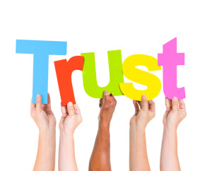 Diverse People Holding Single Word Trust